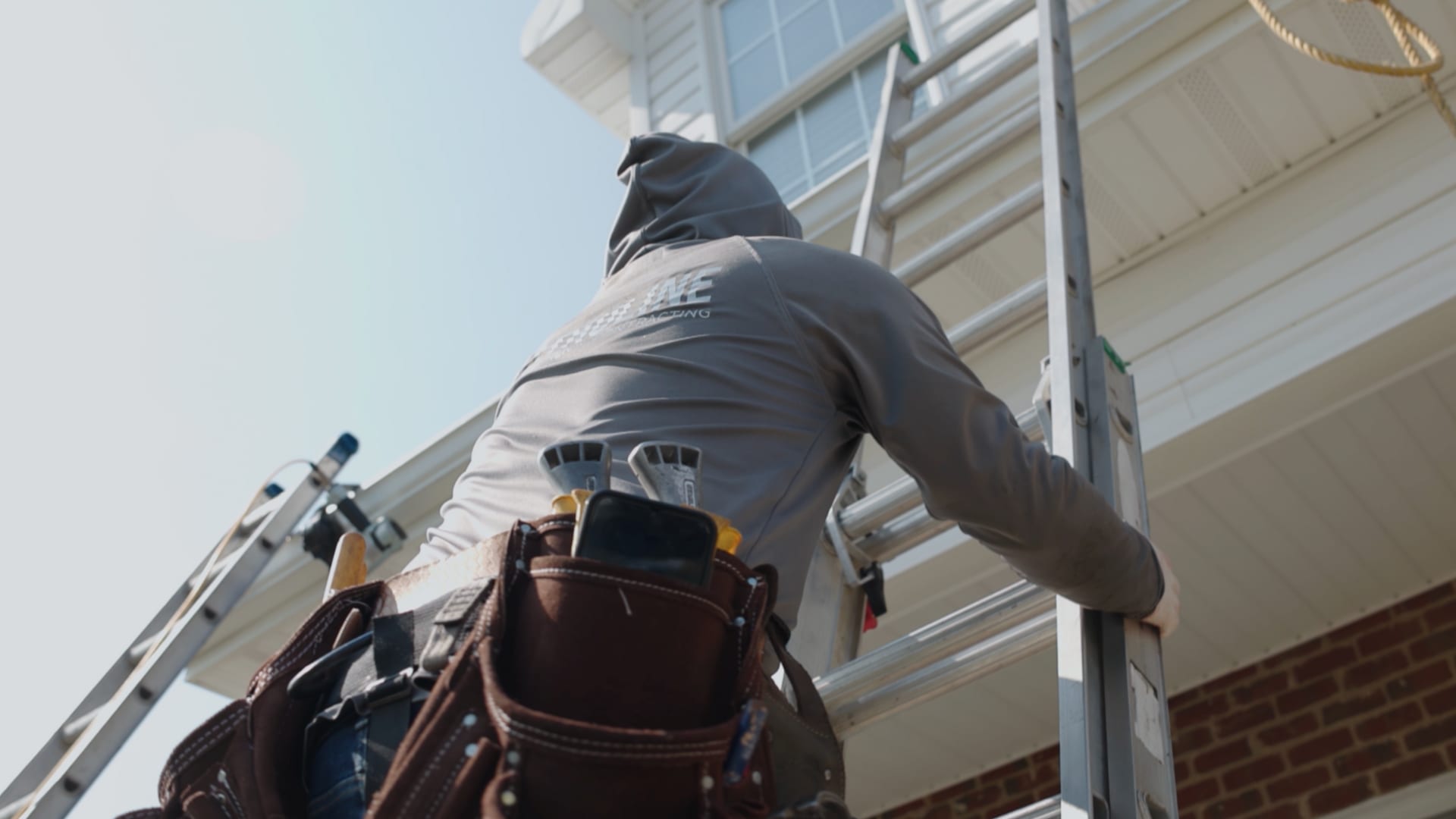 TRULINE crew working on a West Virginia rooftop at sunrise
