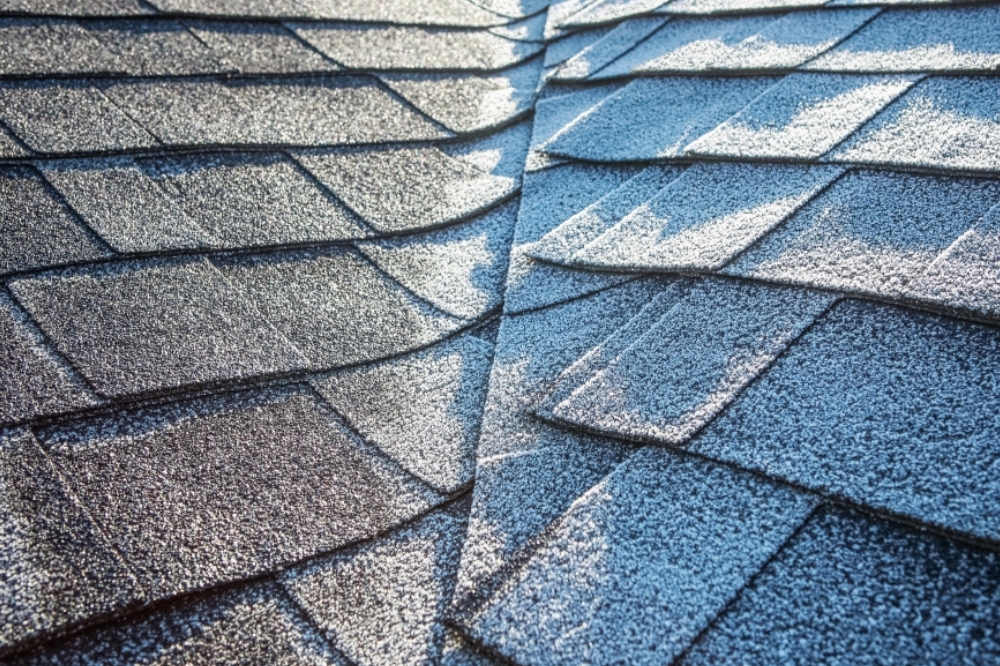 Snow and ice accumulation on a residential roof in West Virginia winter