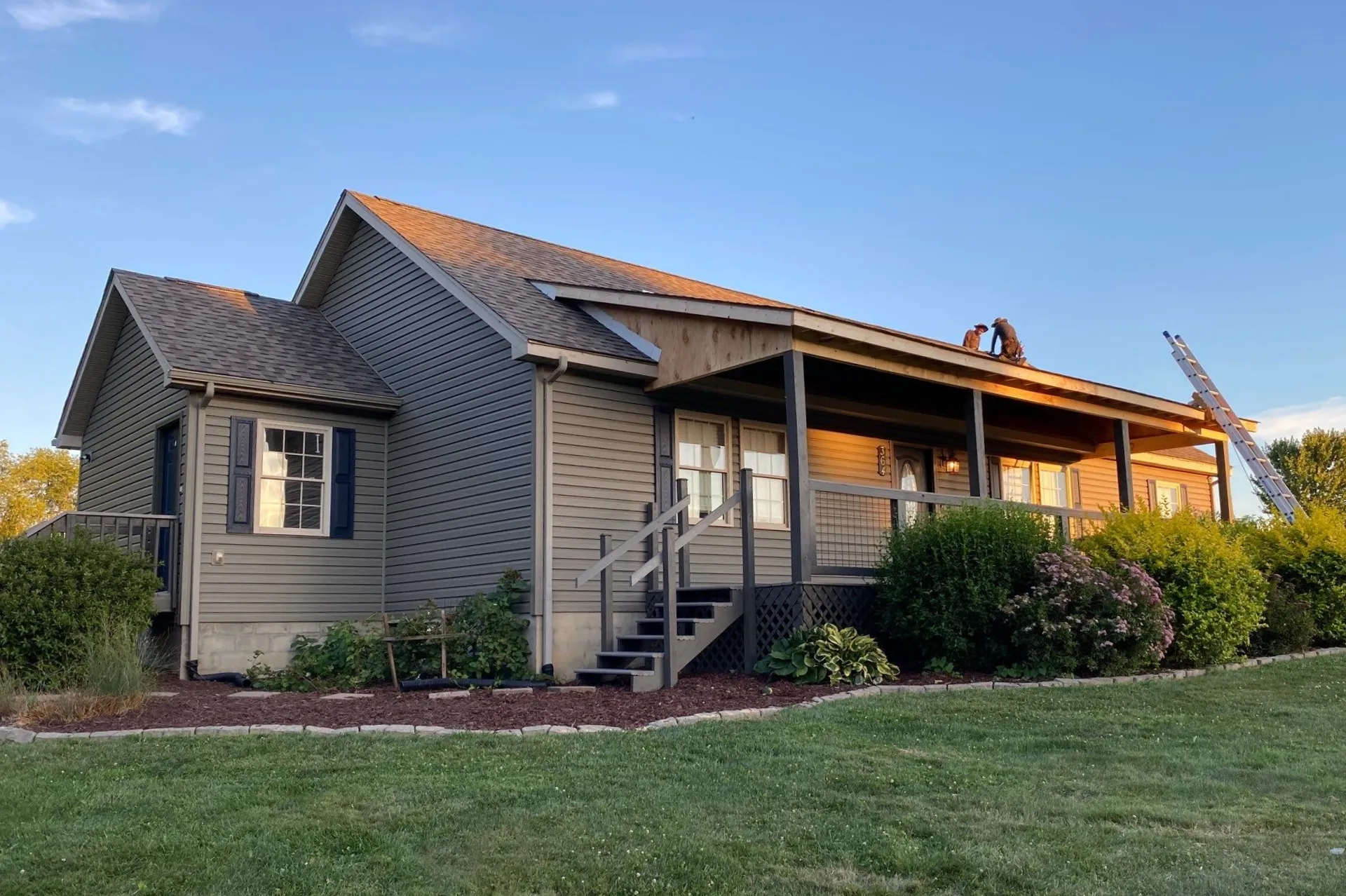 Shingle roof on gray home with porch in Fayetteville, WV