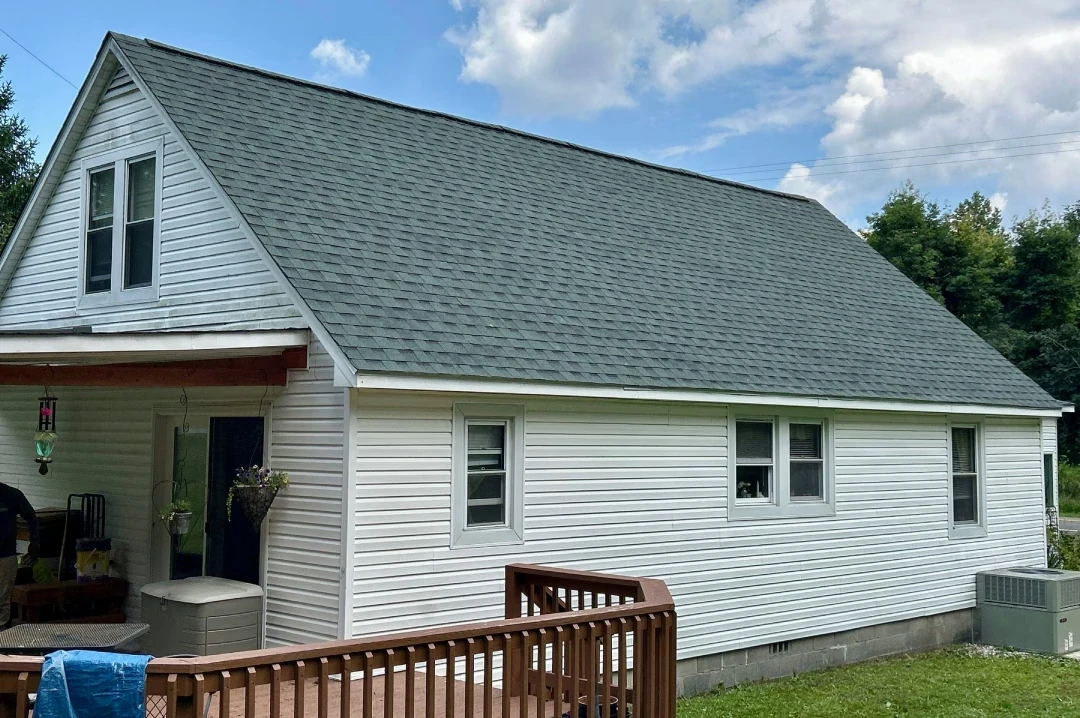 Green-tone shingle roof on white home in Peterstown, WV